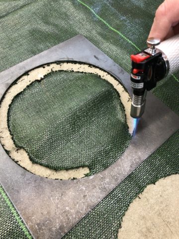 Burning a hole in a garden mat